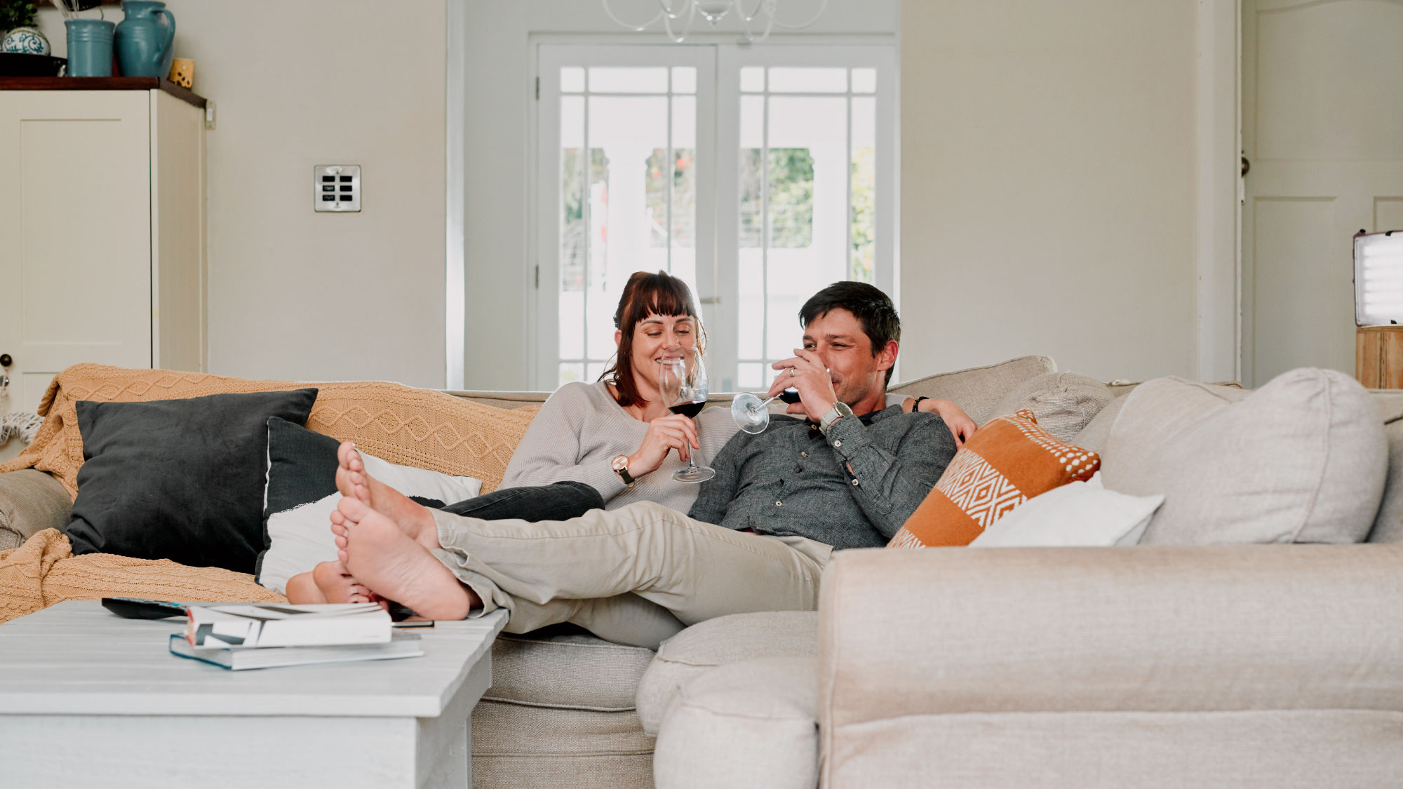 Couple relaxing in their air conditioned cool house.